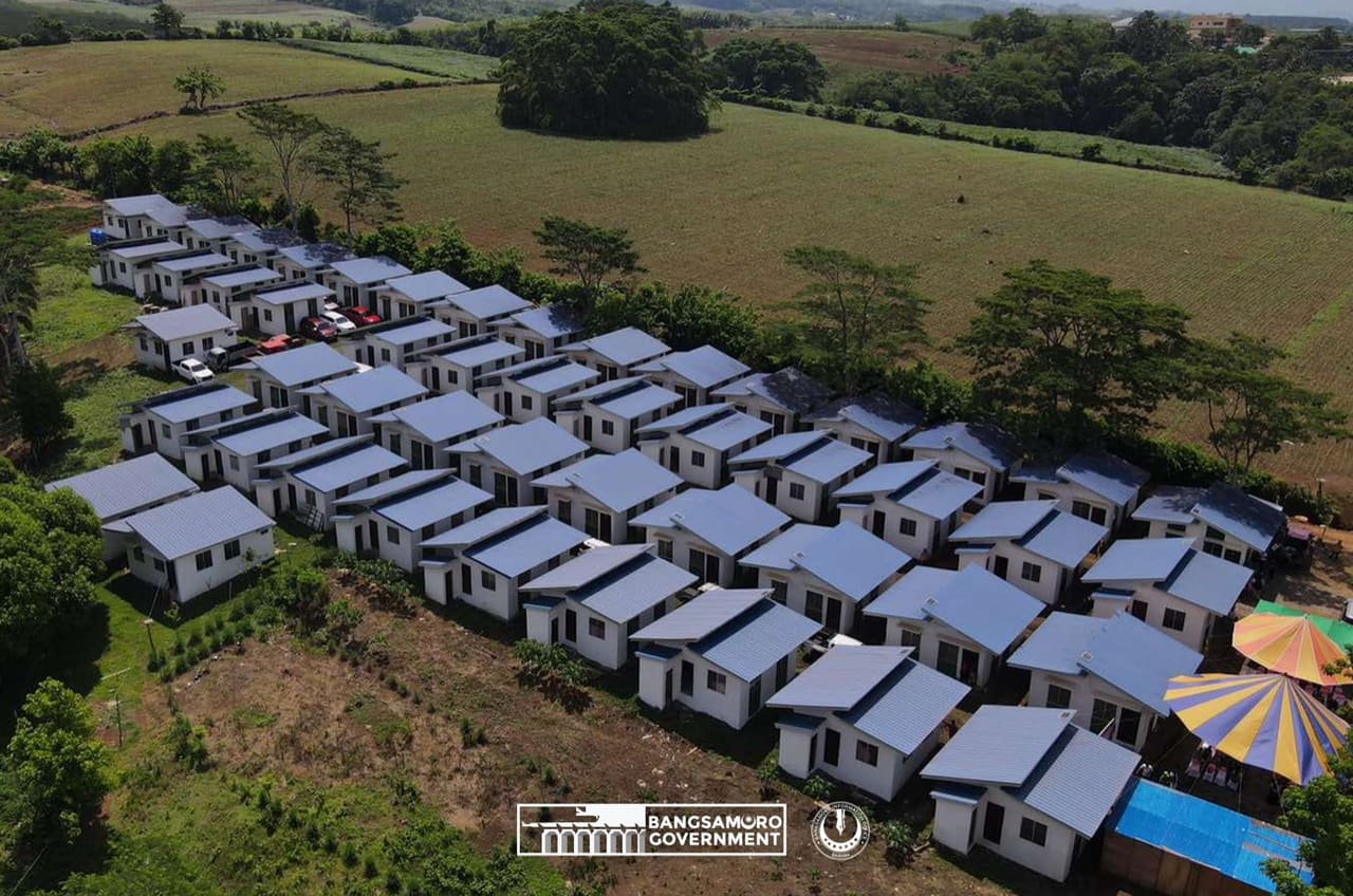 Aerial view of the 50 KAPYANAN housing units at Barangay Buot, Wao, with farmland behind