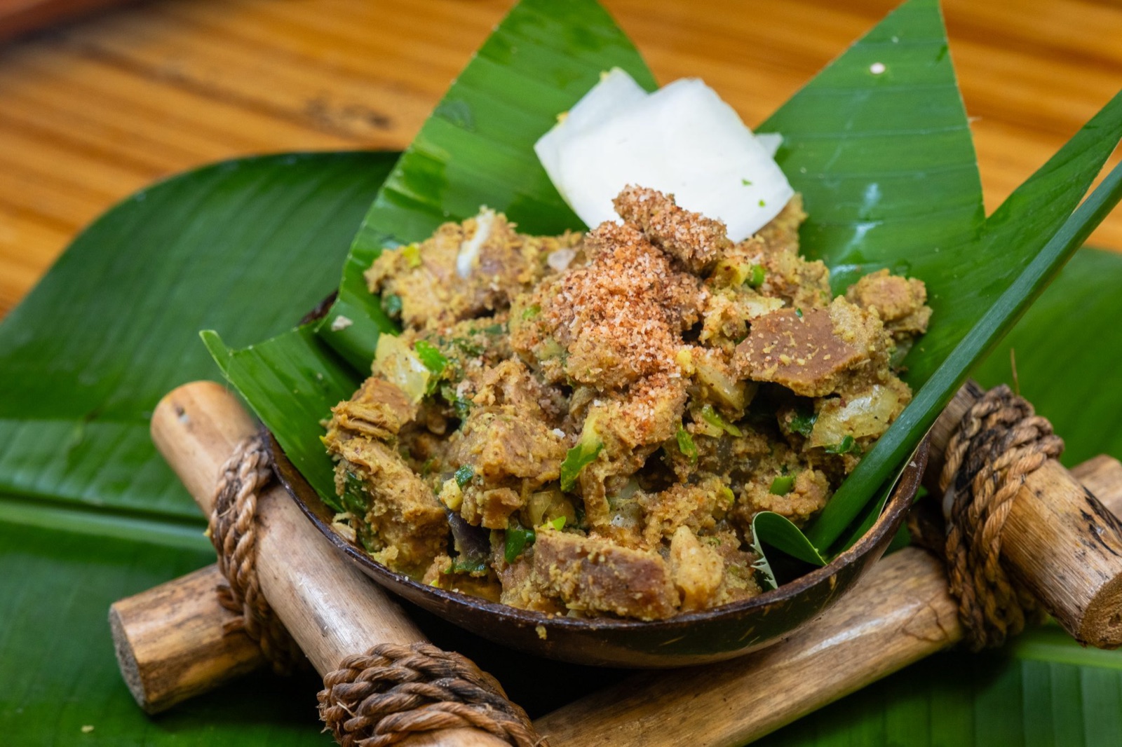 Beef sinina, a Maguindanaon dish of beef in spiced coconut, served on a banana leaf.
